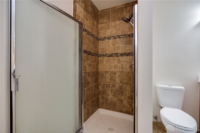 bathroom featuring walk in shower and toilet