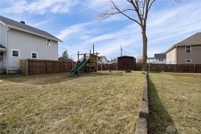 view of yard with a playground and a shed