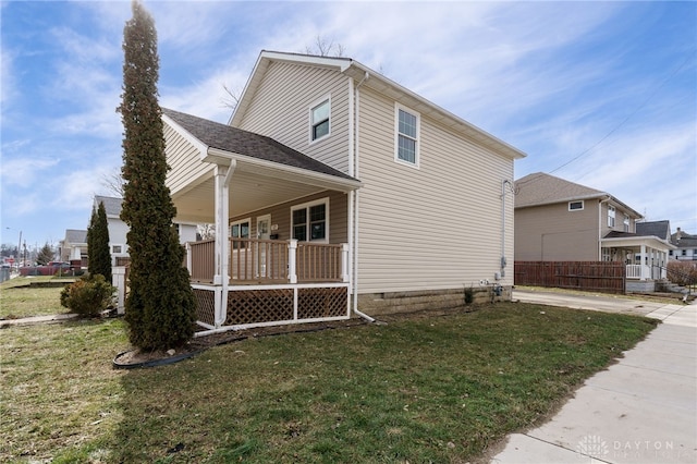 view of property exterior featuring a lawn and covered porch