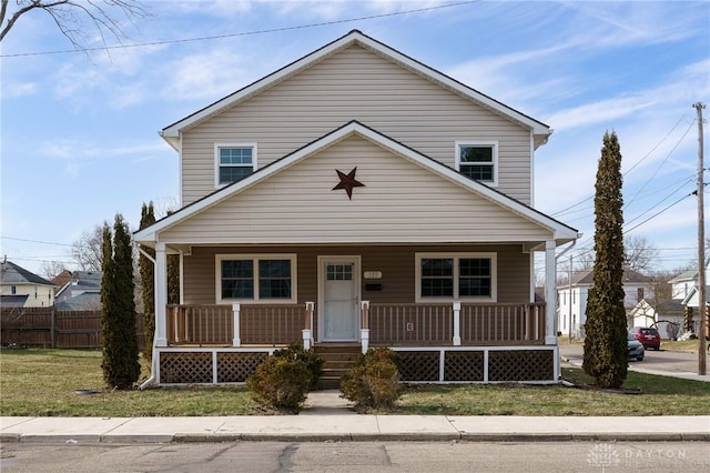 view of front facade with a front yard and covered porch