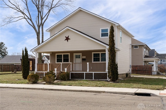 view of front of property featuring covered porch and a front yard