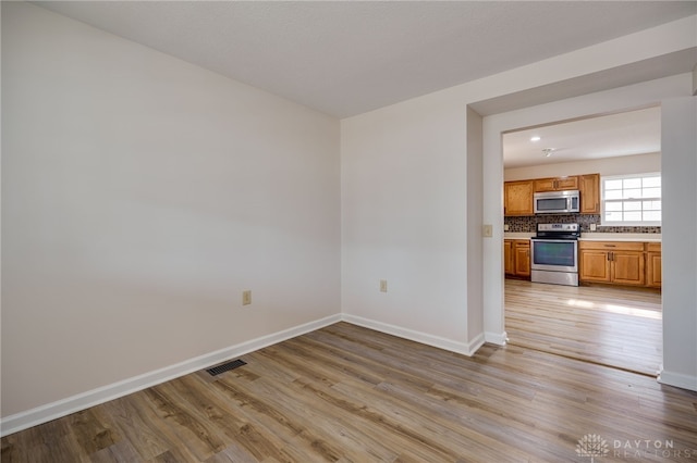 empty room with light hardwood / wood-style floors