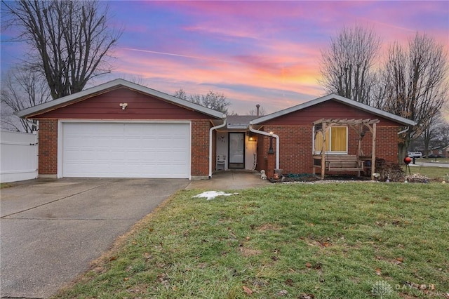 ranch-style home with a garage and a lawn