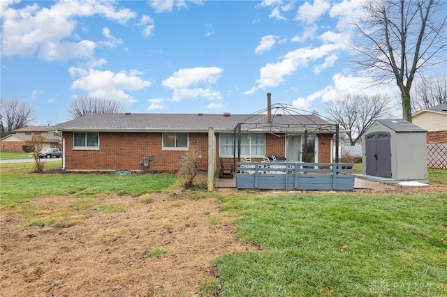 back of house with a storage shed, a yard, and a deck