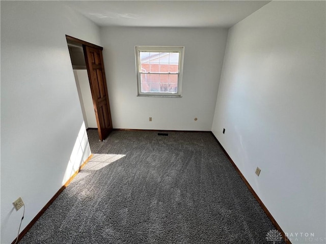 unfurnished bedroom featuring dark carpet