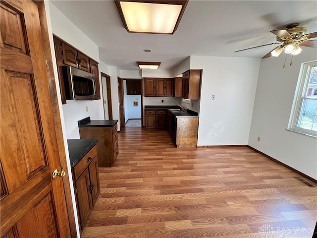 kitchen with sink, light hardwood / wood-style floors, and ceiling fan