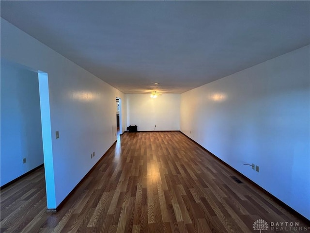 spare room with dark hardwood / wood-style flooring