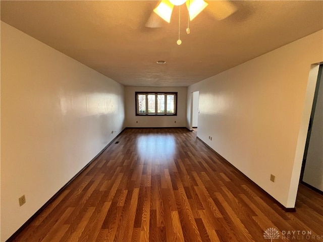 empty room with dark hardwood / wood-style floors