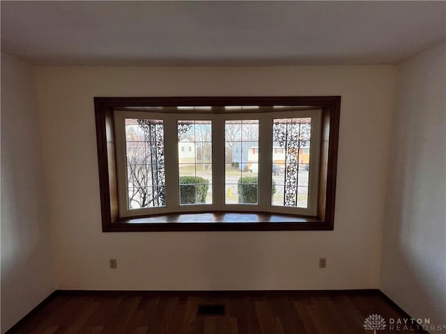 unfurnished room with dark hardwood / wood-style floors