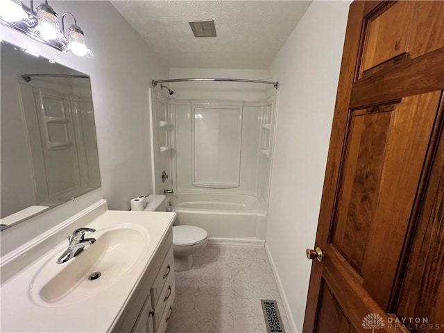 full bathroom featuring vanity, toilet, a textured ceiling, and  shower combination