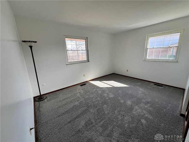 unfurnished room featuring carpet