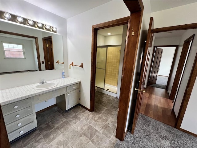 bathroom with an enclosed shower and vanity