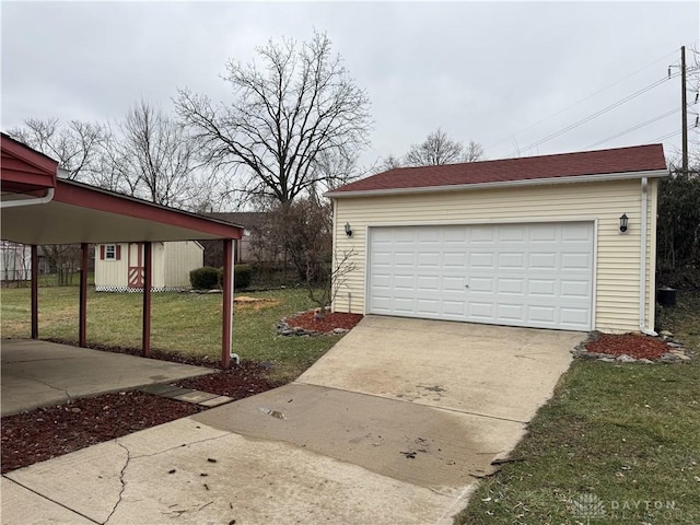 garage featuring a carport and a yard