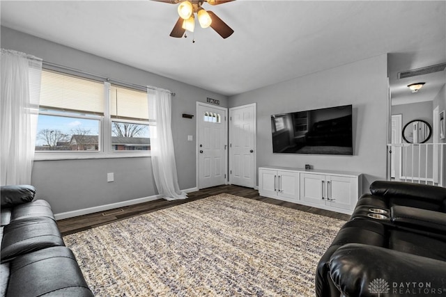 living room with ceiling fan and dark hardwood / wood-style floors