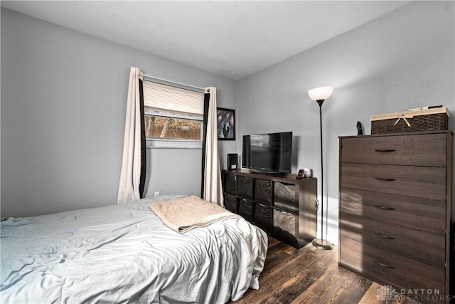 bedroom featuring dark hardwood / wood-style floors and vaulted ceiling