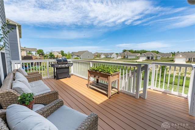 wooden deck with area for grilling and an outdoor living space