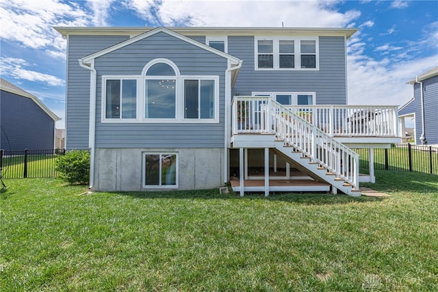 rear view of property featuring a yard and a deck