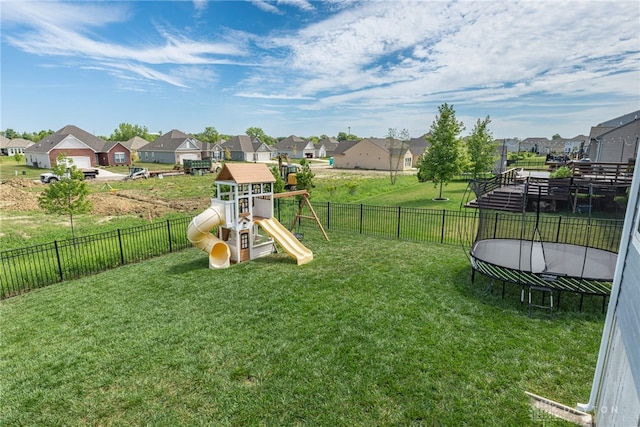 view of play area with a yard and a trampoline