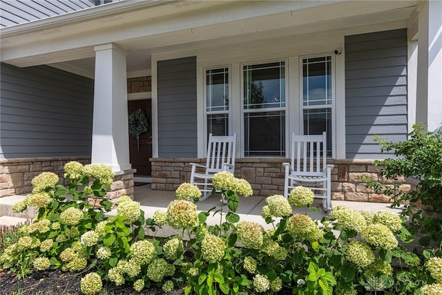 view of exterior entry with covered porch