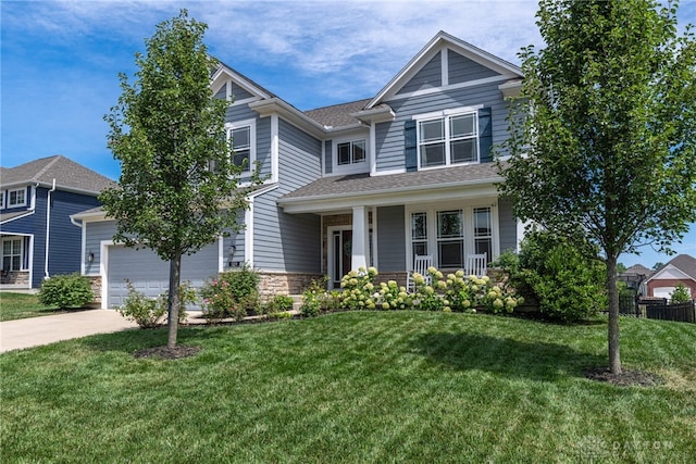 craftsman-style house with a garage, a front lawn, and covered porch