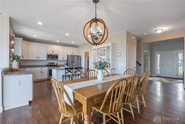 dining space featuring an inviting chandelier, dark hardwood / wood-style floors, and sink