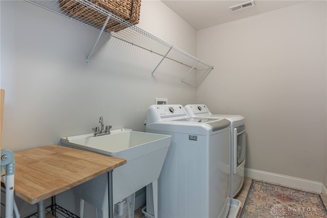 laundry room featuring sink and washer and dryer