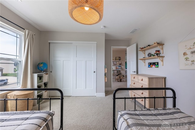 bedroom with a closet and light carpet