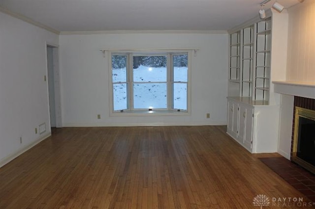 unfurnished living room with crown molding and dark hardwood / wood-style flooring