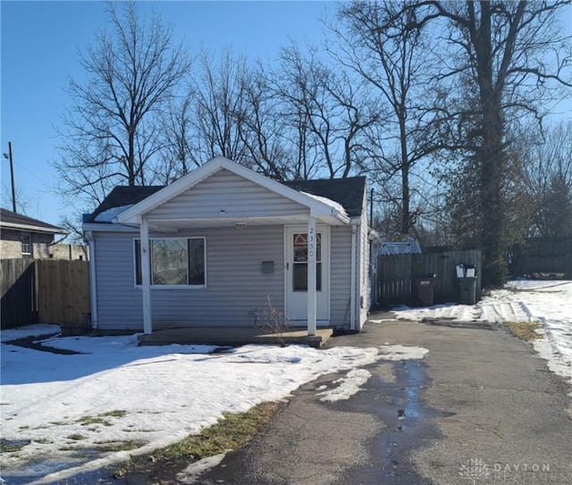 bungalow-style home with fence