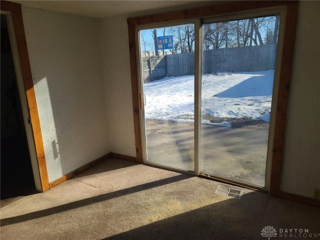 doorway to outside featuring carpet flooring