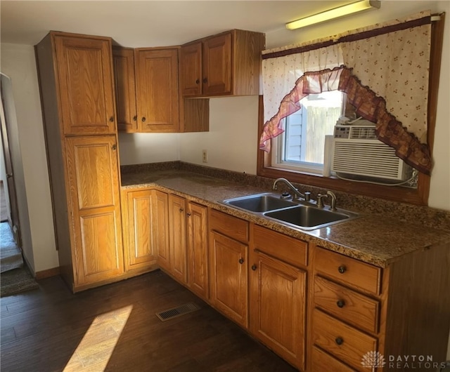 kitchen featuring cooling unit, sink, and dark wood-type flooring