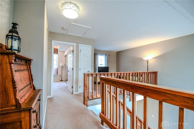 hallway with light colored carpet