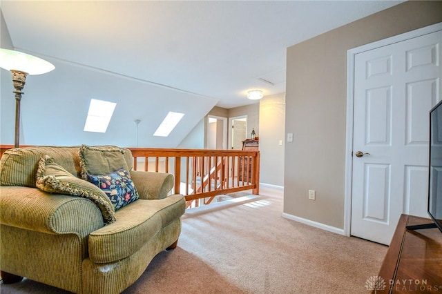 sitting room featuring carpet flooring and lofted ceiling with skylight