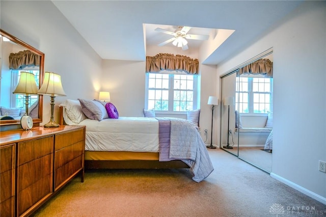 bedroom featuring light carpet, lofted ceiling, and ceiling fan