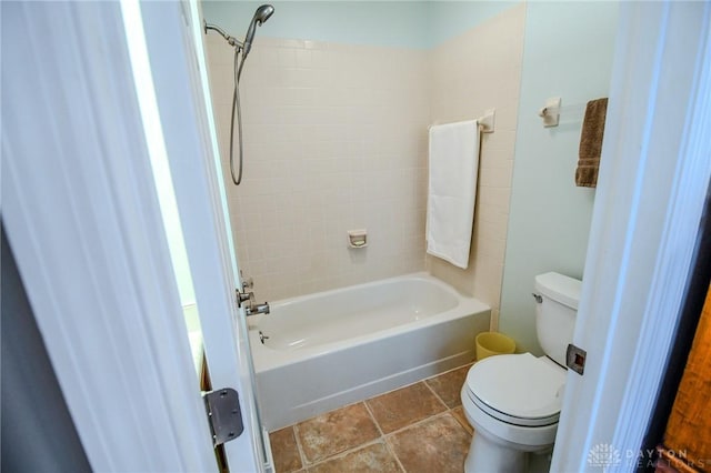 bathroom featuring tiled shower / bath and toilet