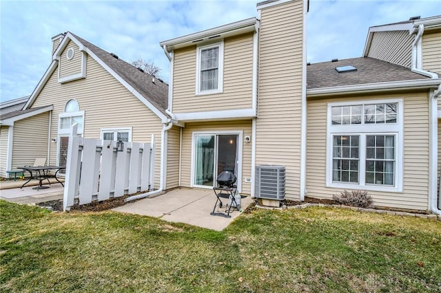 back of house featuring a yard, a patio area, and central air condition unit