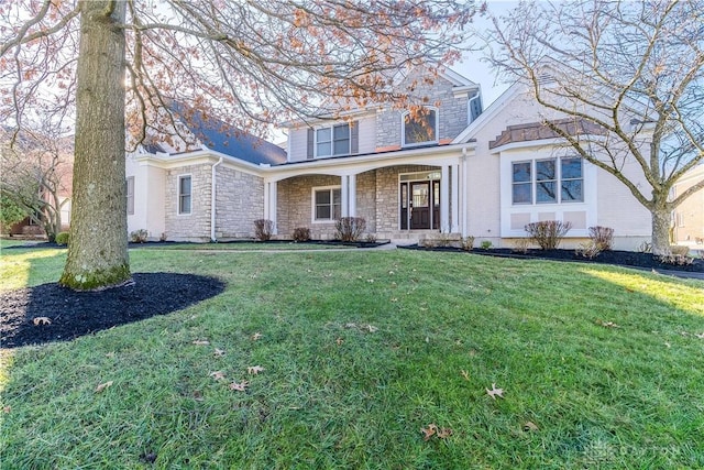 view of front property featuring covered porch and a front lawn