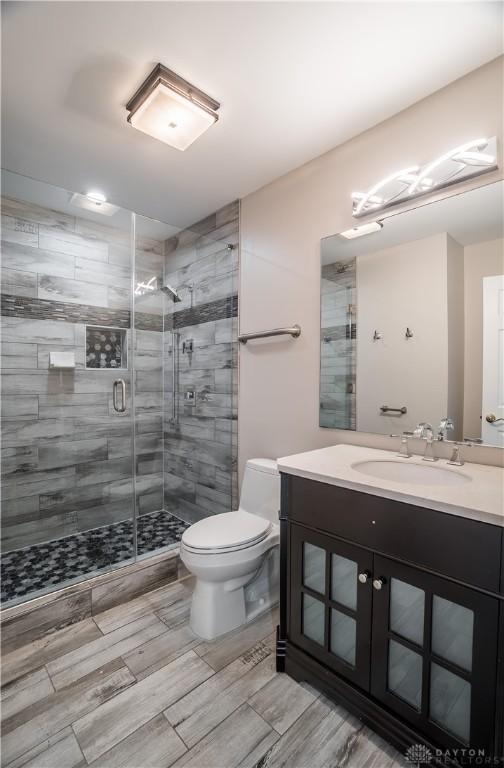 bathroom with vanity, toilet, and walk in shower