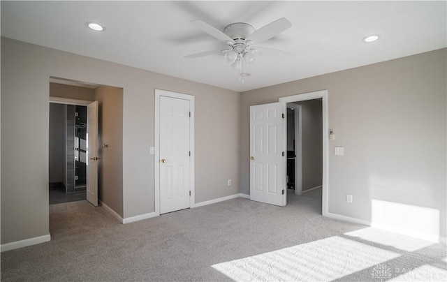 unfurnished bedroom featuring light carpet and ceiling fan