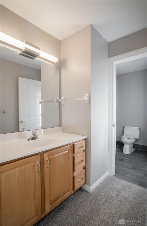 bathroom featuring vanity and toilet