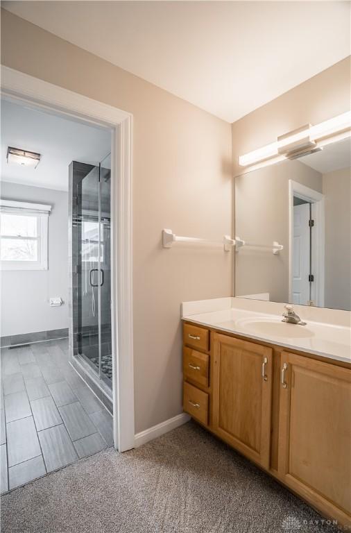 bathroom featuring vanity and an enclosed shower