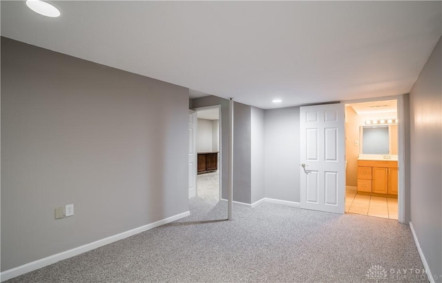 basement featuring light colored carpet