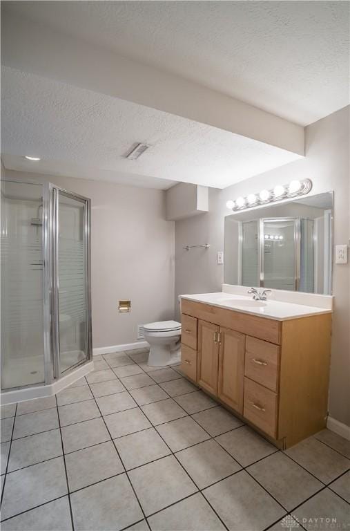 bathroom featuring vanity, tile patterned floors, a textured ceiling, and walk in shower