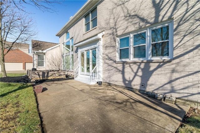 view of side of home featuring a patio area and a lawn