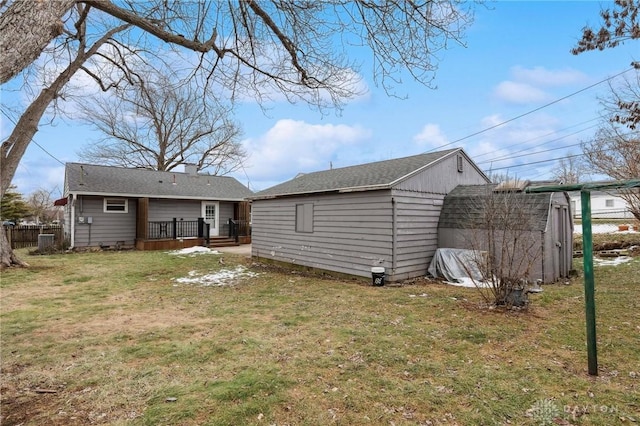 back of house with a lawn