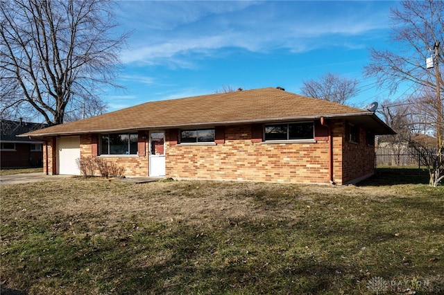 ranch-style home with a garage and a front yard