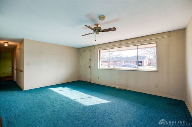 carpeted spare room featuring ceiling fan