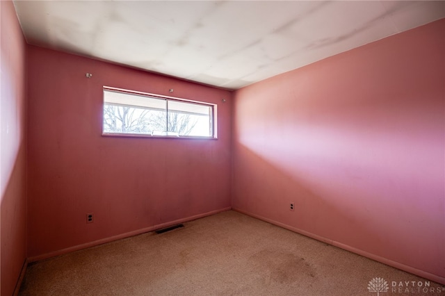 unfurnished room with light colored carpet