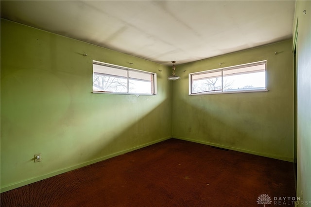 basement featuring dark carpet