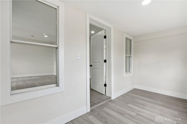 corridor with light hardwood / wood-style flooring